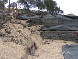 Vertical trench drains were placed normal to the sea. Garden slopes were reformed into berms using reinforced earth and geomembranes